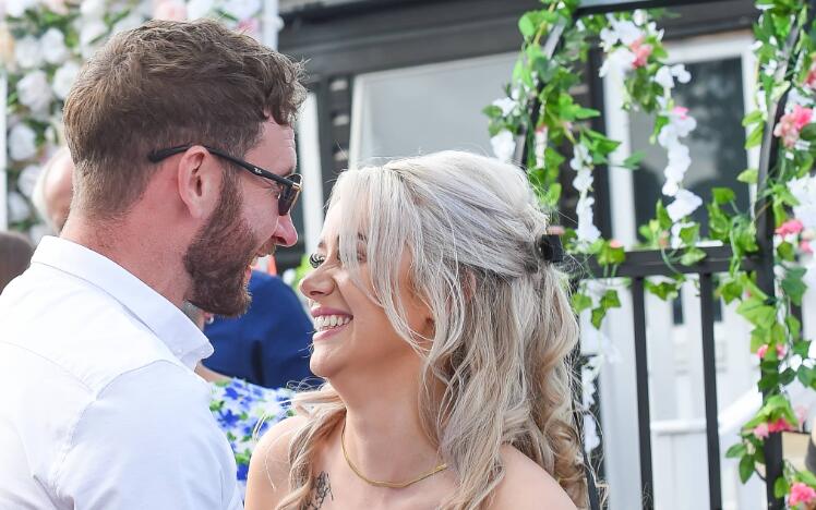 A couple laughing together at the races